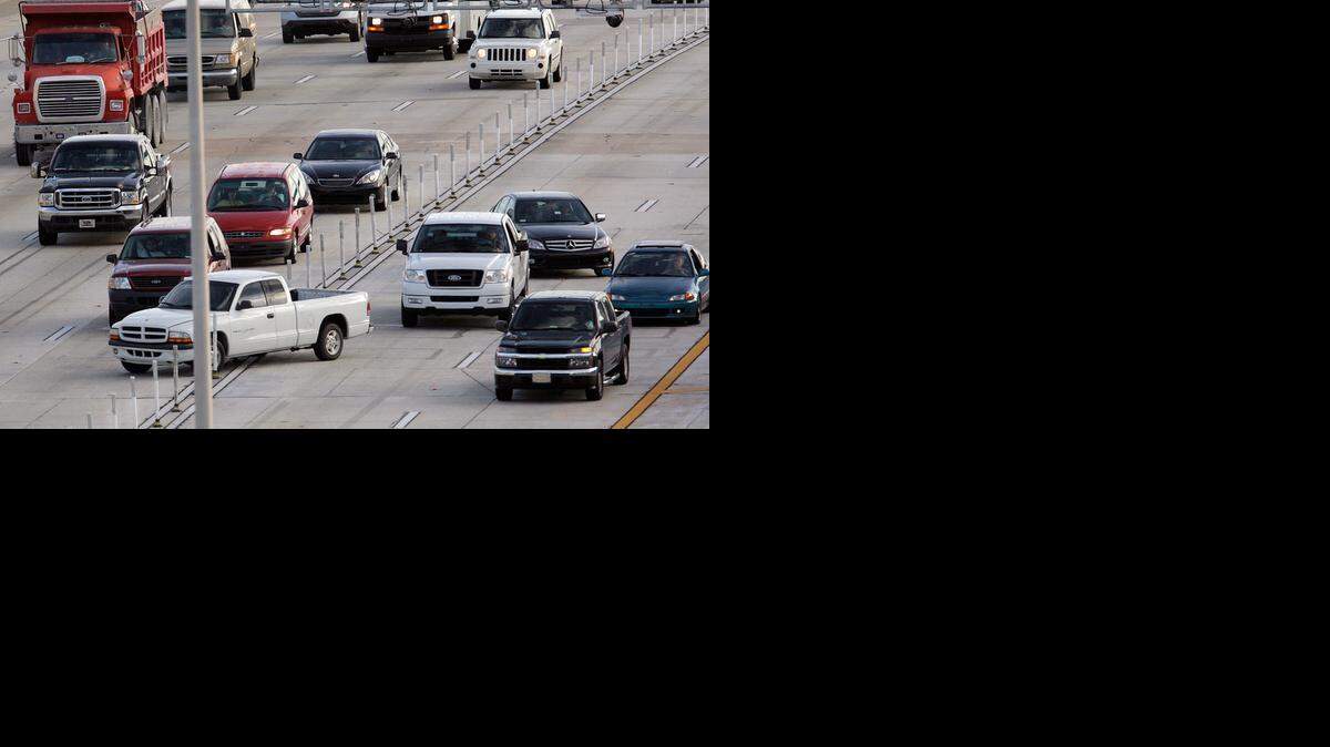 
LANE-DIVING: A pickup truck crosses the barricades separating the northbound I-95 express lanes, right, from normal traffic.
