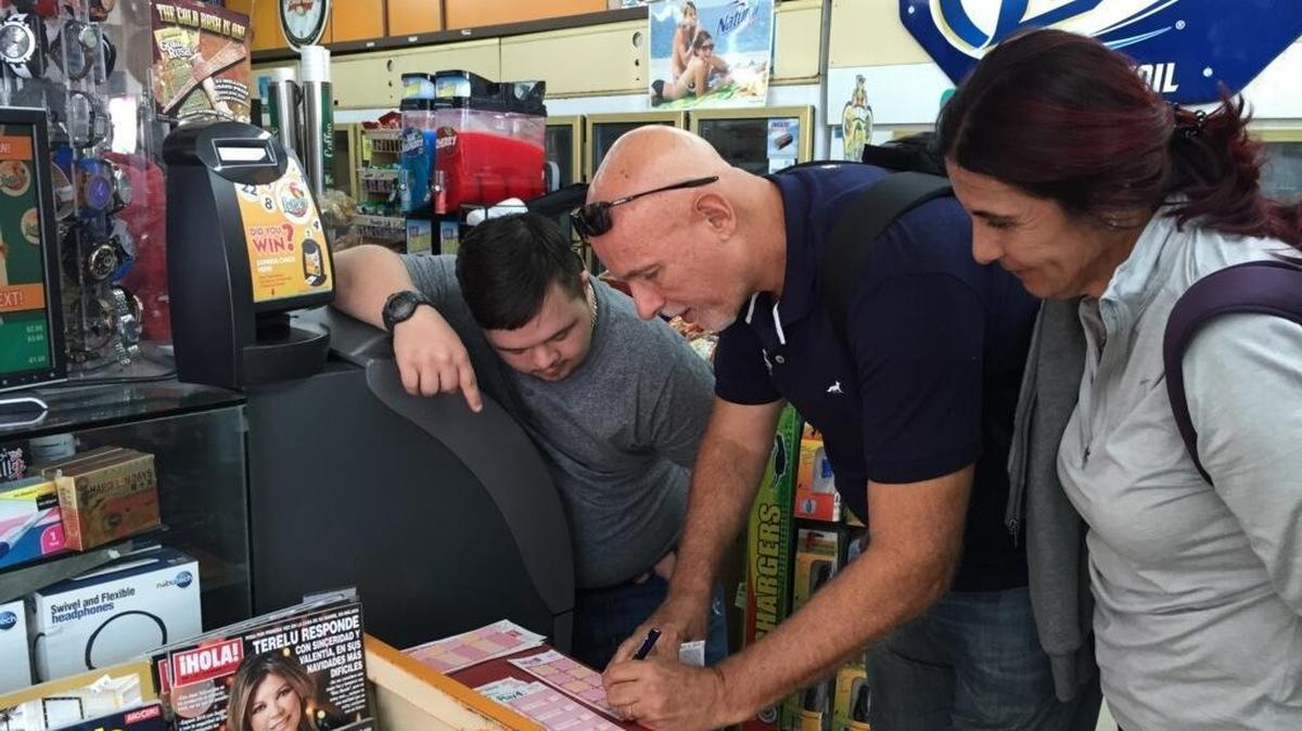 Powerball ticket buyers help each other fill out tickets at a convenience store in Hialeah. The manager has hired an extra employee for the influx of buyers expected before Wednesday’s drawing.