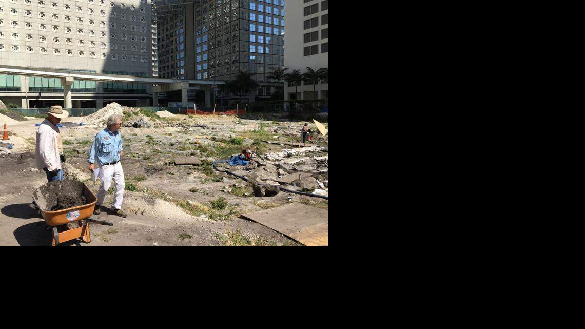 
Archaeological and Historical Conservancy executive director Bob Carr, in blue, and archaeologist Ed Barberio survey the final stages of a dig in downtown Miami on the north bank of the Miami River where workers have found artifacts indicating more than a foot rise in sea level since the late 19th century. Scientists believe industrialization accelerated sea level rise over the last century.
