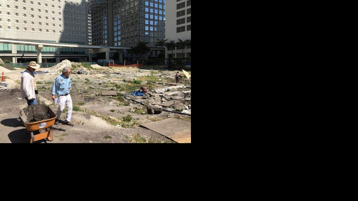 
Archaeological and Historical Conservancy executive director Bob Carr, in blue, and archaeologist Ed Barberio survey the final stages of a dig in downtown Miami on the north bank of the Miami River where workers have found artifacts indicating more than a foot rise in sea level since the late 19th century. Scientists believe industrialization accelerated sea level rise over the last century.
