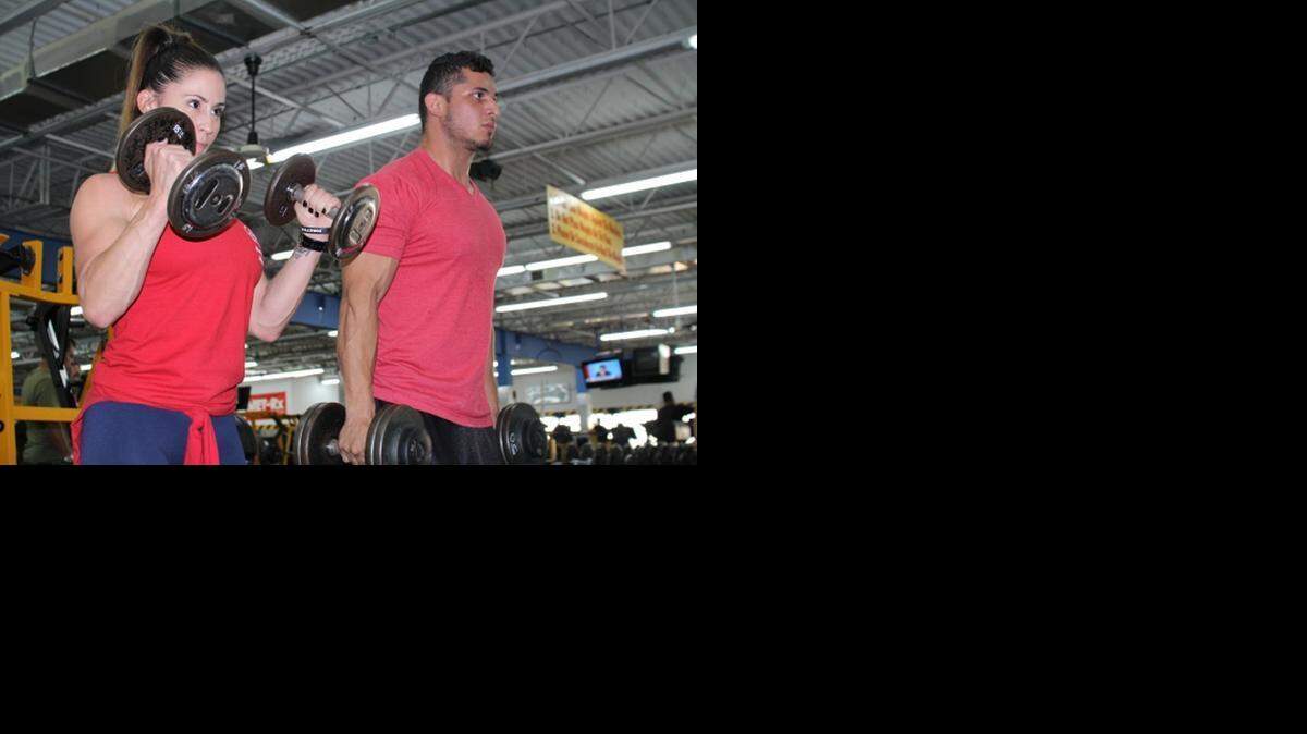 
Cheena Nuñez and Marvin Cardenas workout biceps at the old Porky’s Gym on Coral Way. Donna Cabrera opened the gym in 1991, but sold it to national chain Youfit Health Clubs. Porky’s Gym was one of the few mom-and-pop gyms that catered to hardcore lifters.
