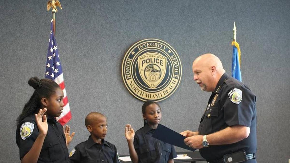 
Christie Baptiste, 11, Kenold Ordenat, 9, and Nae’kia Lawrence, 9, are sworn in as Junior Police Chiefs For a Day by Police Chief Scott Dennis in May 2015.
