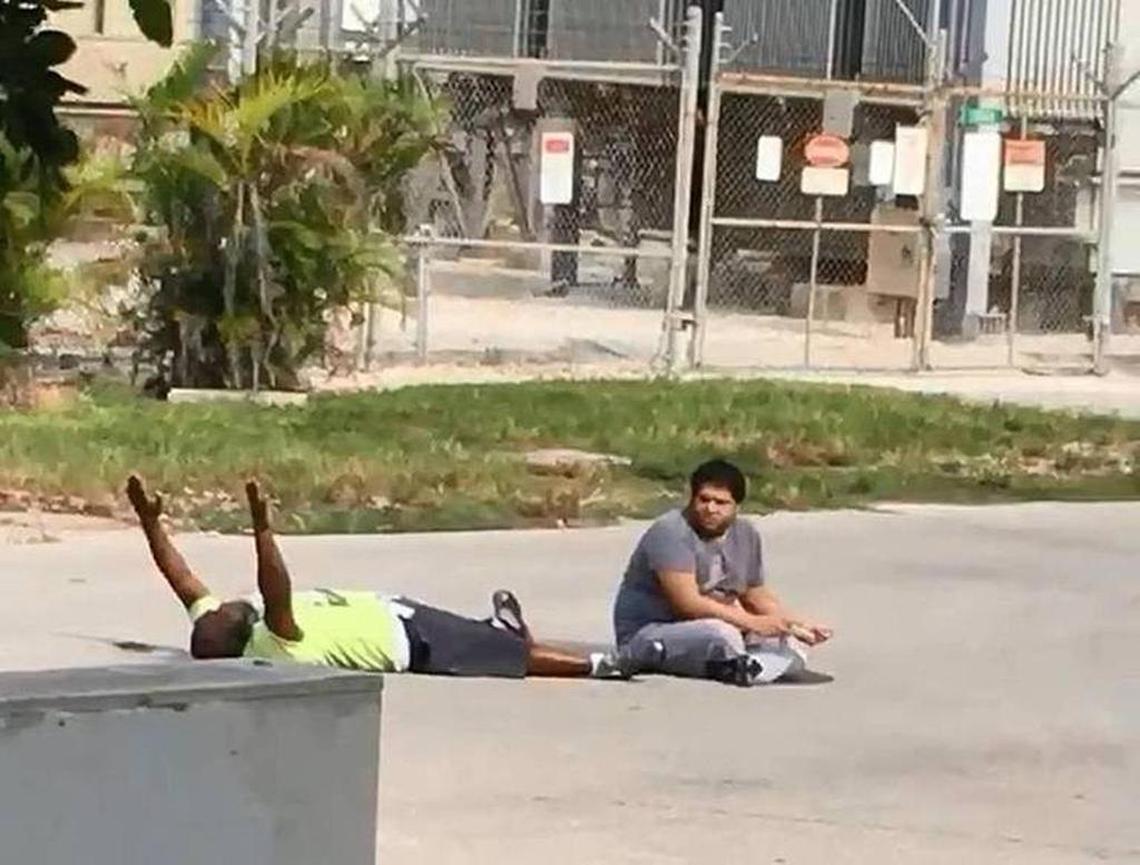 Charles Kinsey is shown lying in the street with his patient Arnaldo Rios before being hit by a bullet from an assault rifle fired by a North Miami Ofc. Jonathan Aledda.