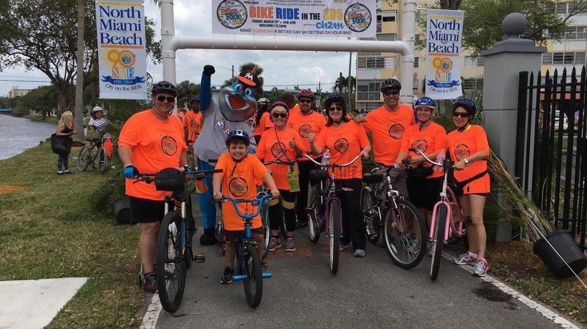 Councilman Anthony DeFillipo, Councilwoman Phyllis Smith, City Manager Ana Garcia, Mayor George Vallejo, Councilwoman Marlen Martell and Councilwoman Barbara Kramer pose for a photo with Miami Marlins mascot Billy, and some residents at North Miami Beach’s Bike Ride in the 305 on March 20, 2016.