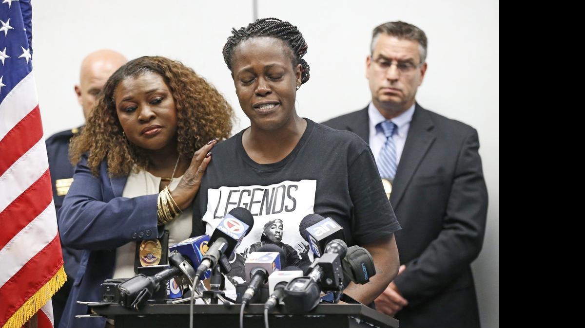 
North Miami Beach Police Detective Cora Mann, left, consoles Jada Ferrell as Ferrell pleads for help from the public in finding information on who killed her son during North Miami Beach police press conference on Friday, July 24, 2015. Police seek details of the murder of Anthony Holley, 16, who was found shot and killed in an alleyway on Sunday.
