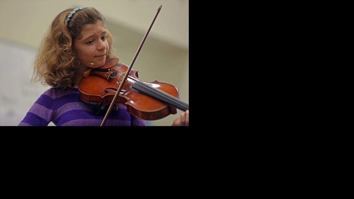 
Biana Pinchuk, an 11-year-old child prodigy from Sunny Isles who sings opera and pop in six languages, performs at the David Lawrence K-8 Center Monday, Jan. 12, 2015.
