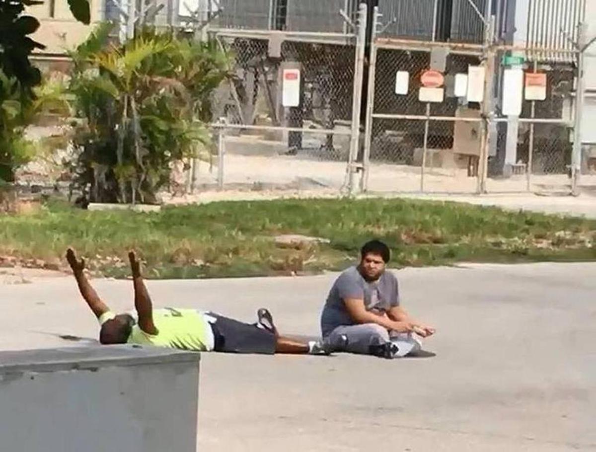 Charles Kinsey is shown lying in the street with his patient Arnaldo Rios before being shot by a North Miami police officer, Jonathon Aledda.