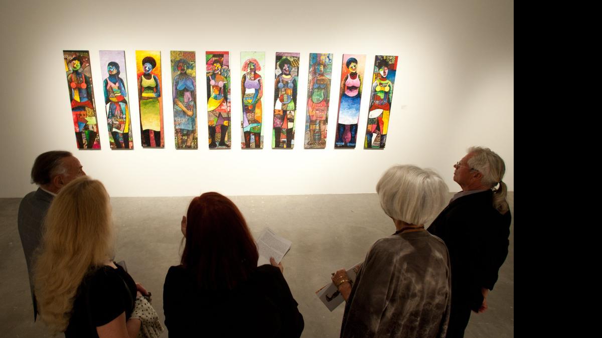 
Visitors check out part of the Shifting the Paradigm exhibit at the Museum of Contemporary Art in North Miami during the opening reception of the show in December 2014. The City Council approved more than $1 million in funding to help the museum operate through the end of the year.
