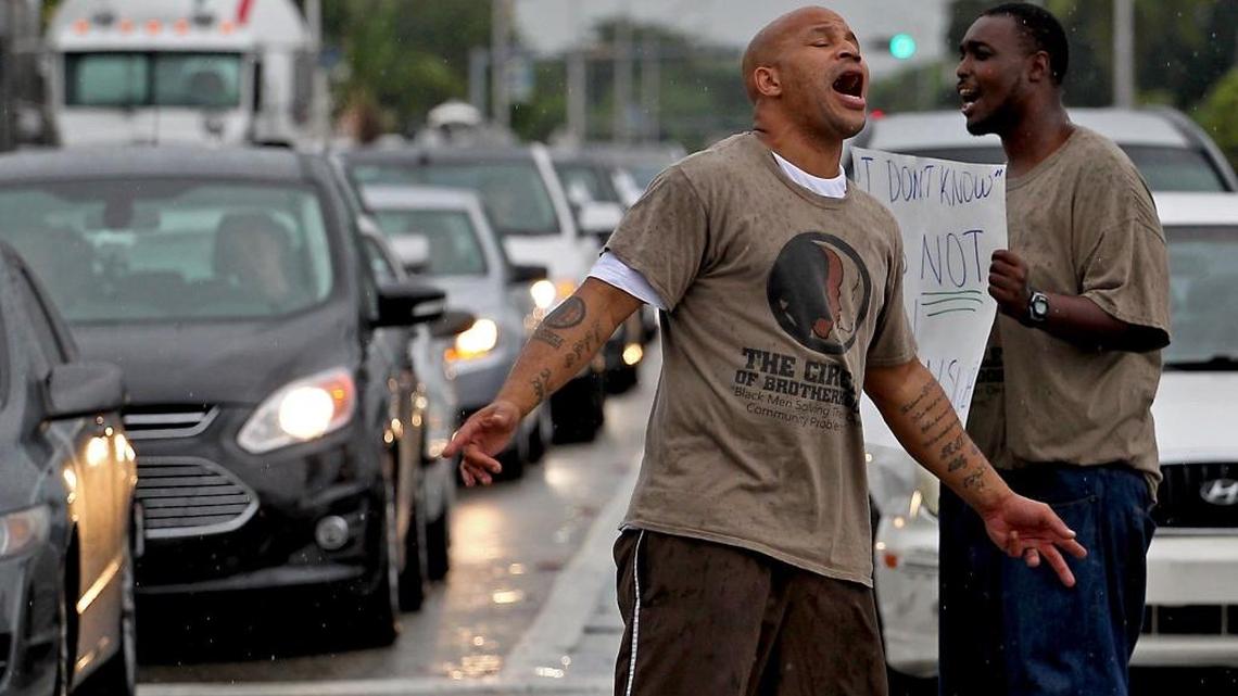 Anthony Blackman and about two dozen other protesters block rush hour traffic at Northeast Sixth Avenue and 125th Street in North Miami on Monday demanding that North Miami police officer Jonathan Aledda be charged in the shooting of Charles Kinsey. The behavioral therapist was shot July 18 as he tried to assist his autistic patient, who had wandered from his group home. The shooting is under investigation by the Florida Department of Law Enforcement and State Attorney’s office.