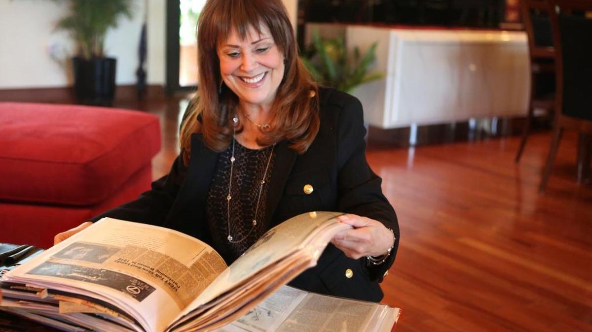 Journalist Suzanne Lasky-Gerard looks through an album with articles and photos of her career to date, on Friday, Jan. 22, 2016, at her North Miami home, where she lives with her fiancé Bill Liebman and their three rescued dogs.