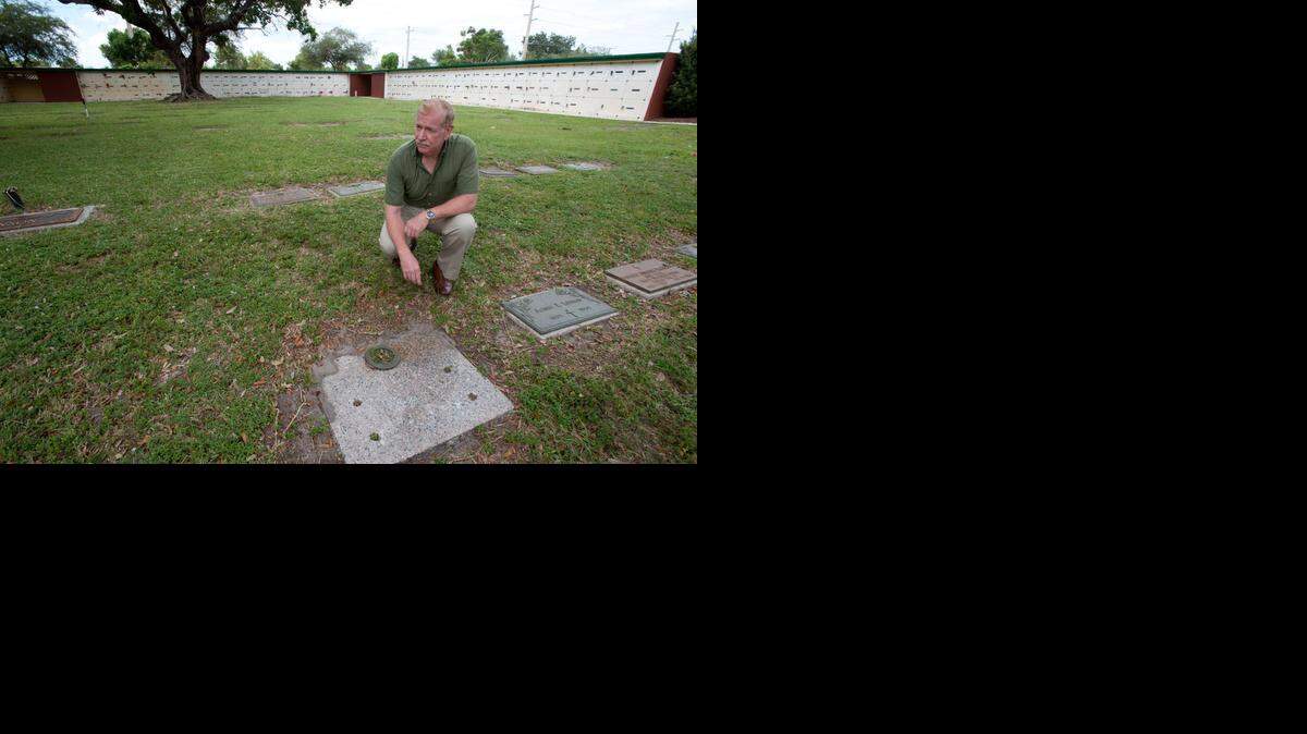 
South Dade resident Al Lopez stands near the grave of Pfc. Robert Randall at Southern Memorial Park Cemetery on Tuesday, Nov. 4, 2014, in North Miami Beach. Lopez and Randall were classmates in junior high school. Randall was killed in action during the Vietnam War. 
