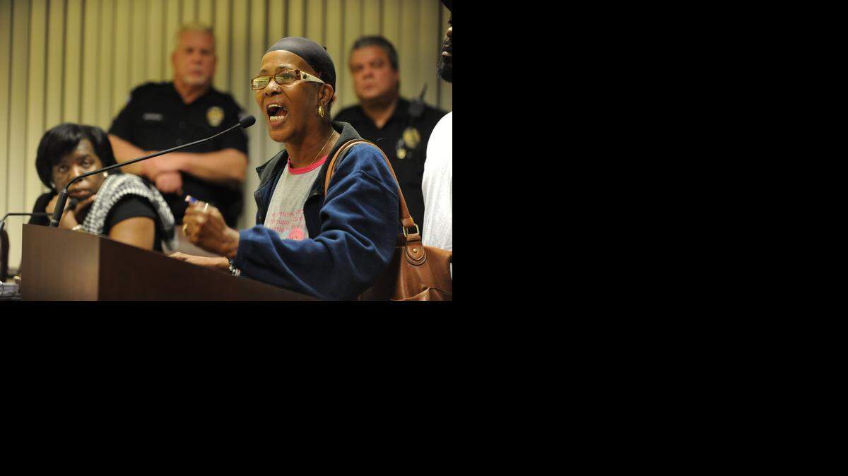 
Upset: Lisa Kelly, the mother of Tyquan Kelly, decrys the use of a nine-year-old mug shot of her son as a shooting target by North Miami Beach police. She spoke during a council meeting Tuesday. 
