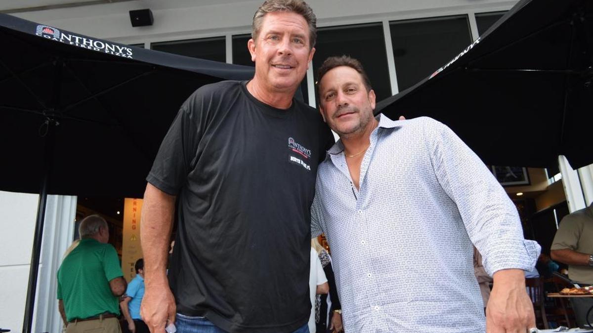 
Miami Dolphins Hall of Fame quarterback Dan Marino and Anthony’s Pizza CEO Anthony Bruno stand together at a reception held on Monday night to welcome the store into the community. 

