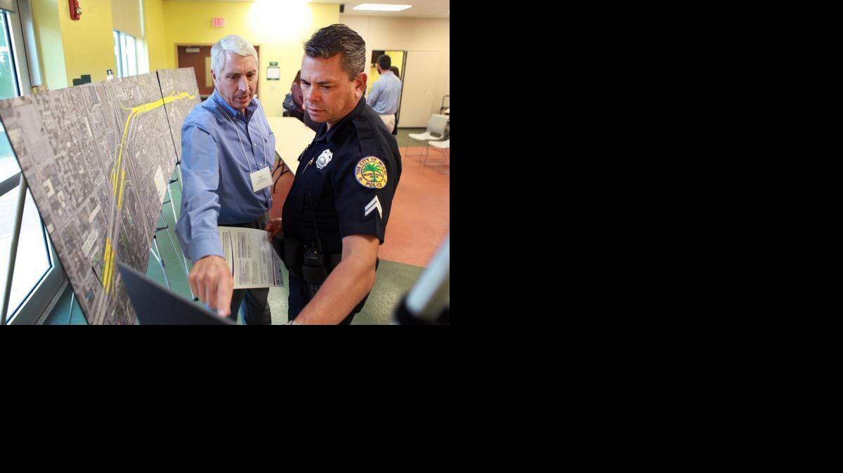 
Transportation executive Mark J. Moshier and Miami police officer Leonardo Carrillo look over plans for a major I-95 project scheduled to start in two years.


