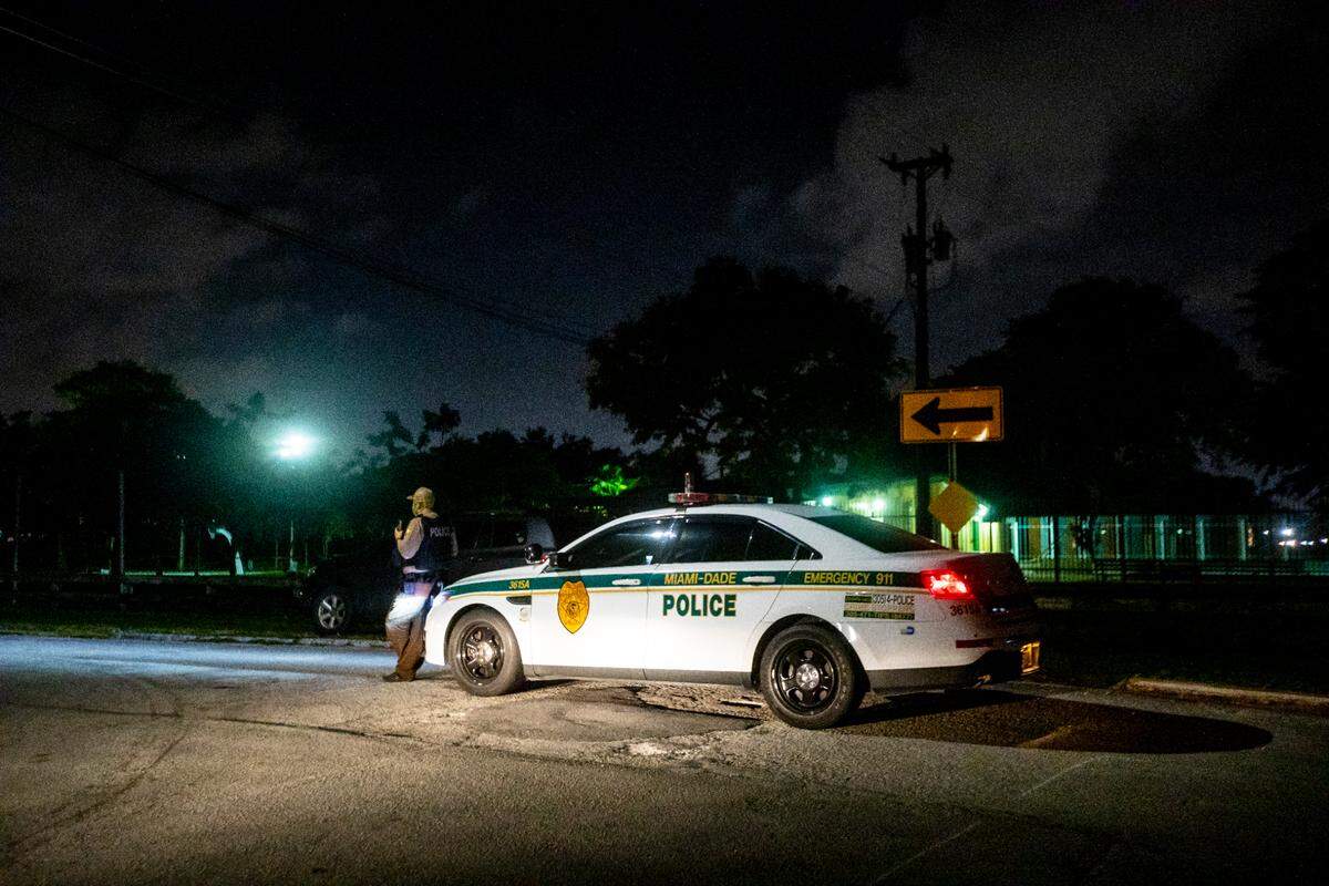 A Miami-Dade police officer stands guard at the site where multiple people were shot at a North Miami-Dade park Sunday night near Northwest 105th Street and Northwest 25th Avenue, according to Miami-Dade Police. at Little River Park in Miami, Florida, January 3, 2021.