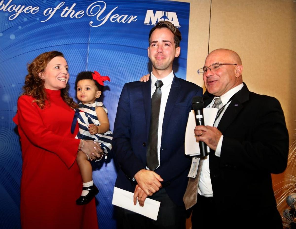 From left, Alessandra Rossi, holding her daughter Mia, MIA Hotel employee Jose Consuegra, and MIA chief of staff Joseph F. Napoli. Consuegra helped save Mia’s life in May by performing CPR when she stopped breathing during a stay at the hotel. On Thursday, he was recognized as MIA’s 2017 Employee of the Year.