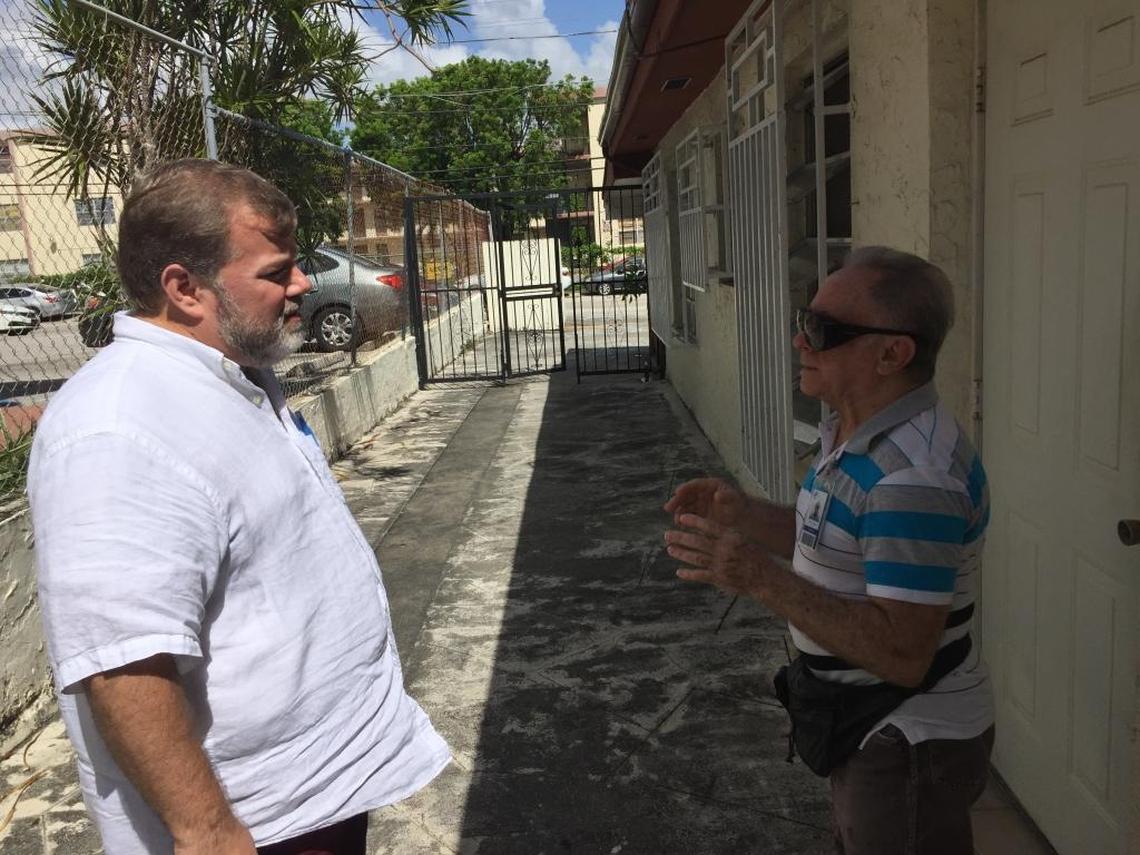José Suárez, left, talks with supporter Redelio Conesa Wednesday morning.