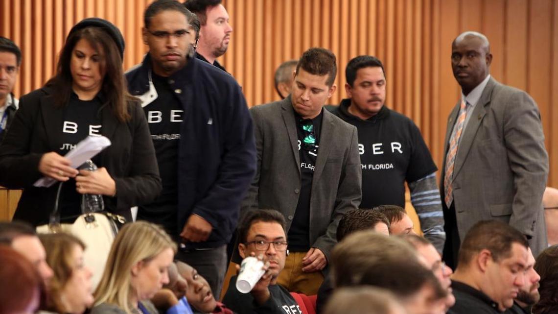 Uber drivers get seated at the Miami-Dade County Commission meeting Wednesday.