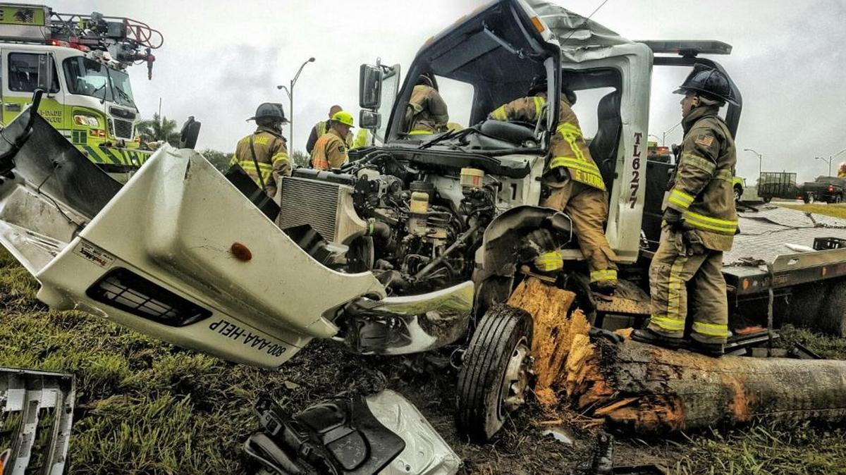 Firefighters rescued a driver who was pinned inside the cab of a truck after it crashed into a tree Sunday afternoon.