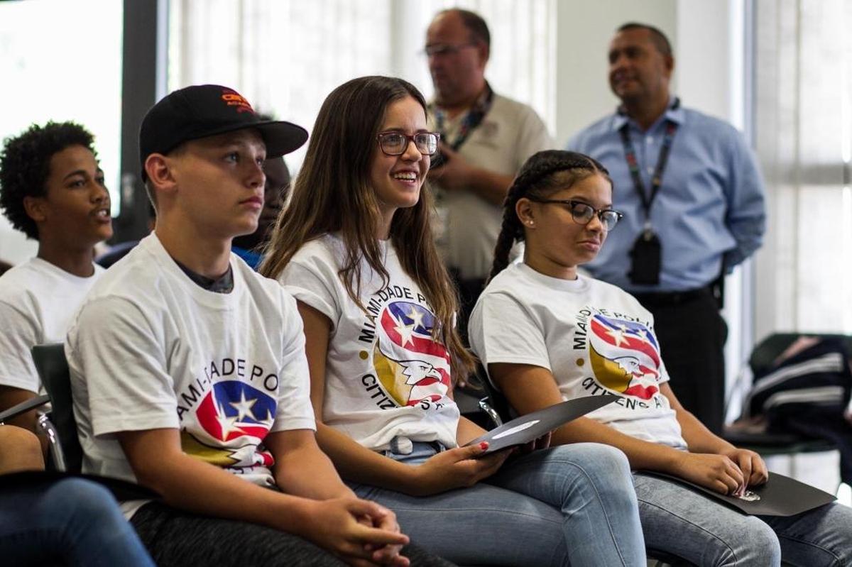 From left, students Corey Gallivan, Danielle Gelpi and Destiny Hall attend the graduation ceremony of Miami-Dade Police Department’s first Teen Citizen's Police Academy at the department’s headquarters in Doral on Friday, Aug. 18, 2017.