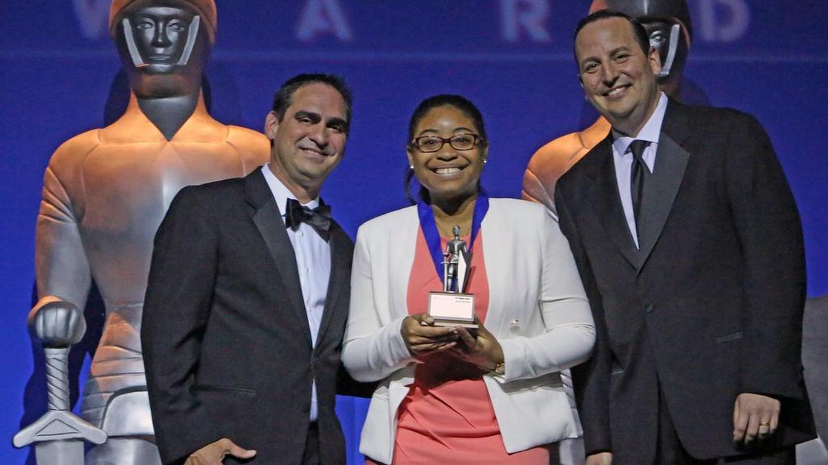 Silver Knight award winner in Social Science, Tiana Headley of Mast Academy, standing with Orlando Comas, at left, Senior Director, Strategic Growth, Miami Herald Media Company and Michael Jellson, at right, Director of SMB & Automotive Sales, Miami Herald during the Miami Herald & El Nuevo Herald 60th Year Silver Knight Award at the James L. Knight Center on Thursday, May 17, 2018.