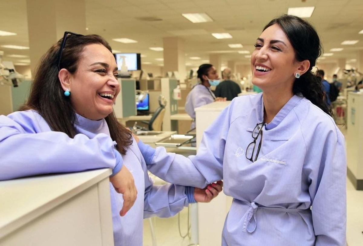 Naghmeh Taherian, left, shares a laugh with her daughter Tara Derakhshandeh at Nova Southeastern University-NSU Dental Program, where they both study dentistry together at the dental clinic on Friday, April 28, 2017.