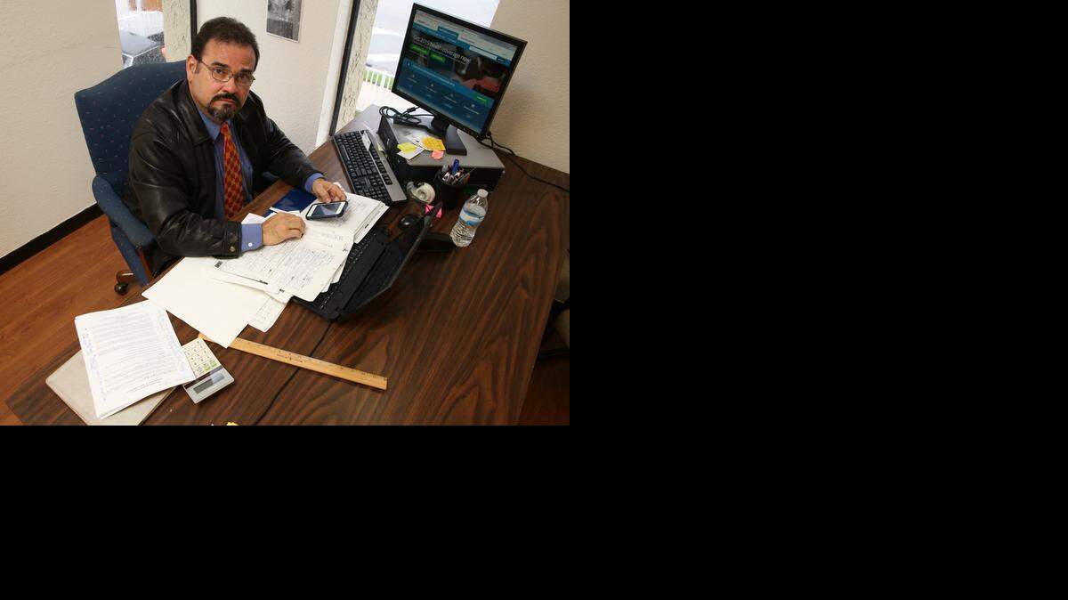 
Alvaro J. Sevilla at his office desk in Miami. Sevilla says Sunshine Life & Health owes him $55,000 in commissions. 
