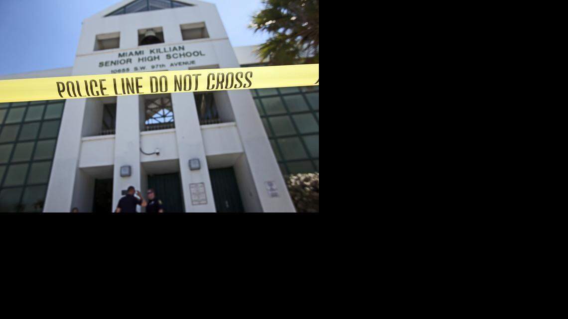 
Police officers watch the front of the school as concerned parents pick up their children at Killian High School in South Miami-Dade on Tuesday, March 31, 2015. A student was stabbed by another student earlier.
