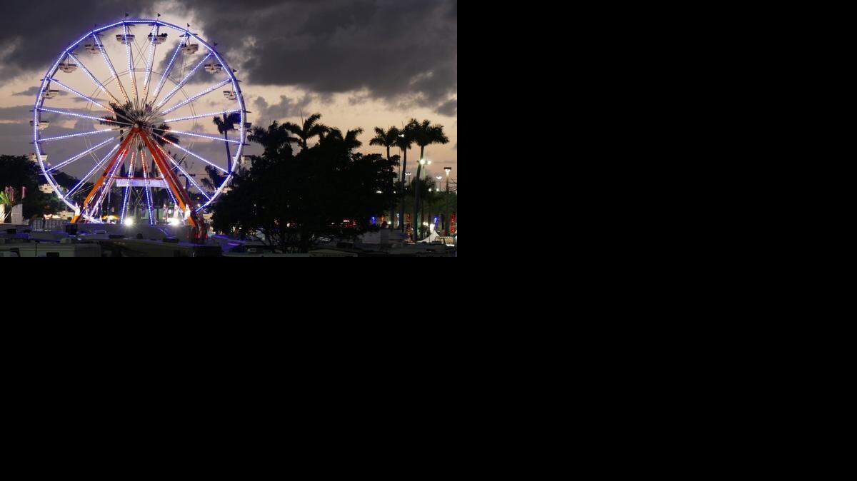 
Ticket holders ride the Ferris wheel as the sun sets on the opening day of the Miami-Dade County Youth Fair on Thursday, March 12, 2015.
