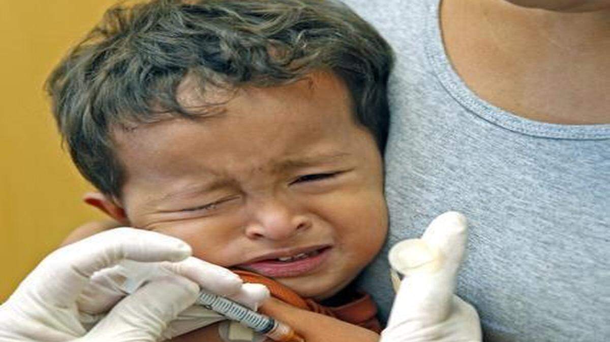 
Yeremit Casco, 2, is held by his mother Dinia Mendoza as he is vaccinated by Jorge Valladares at the Florida Health Miami-Dade County Health District Center on Wednesday, Feb. 11, 2015. As the worst measles outbreak in 20 years sweeps the country, more kindergarteners enter school without their shots in Miami-Dade than in any other Florida county. And more Miami-Dade County parents than ever before are foregoing vaccinations for their kids. 
