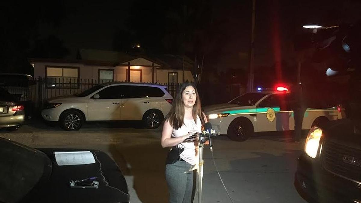 Miami-Dade Det. Jennifer Capote speaks outside a home in Northwest Miami-Dade after police say two men posing as cops entered the home, tied up the occupants and left with a gun and cash.