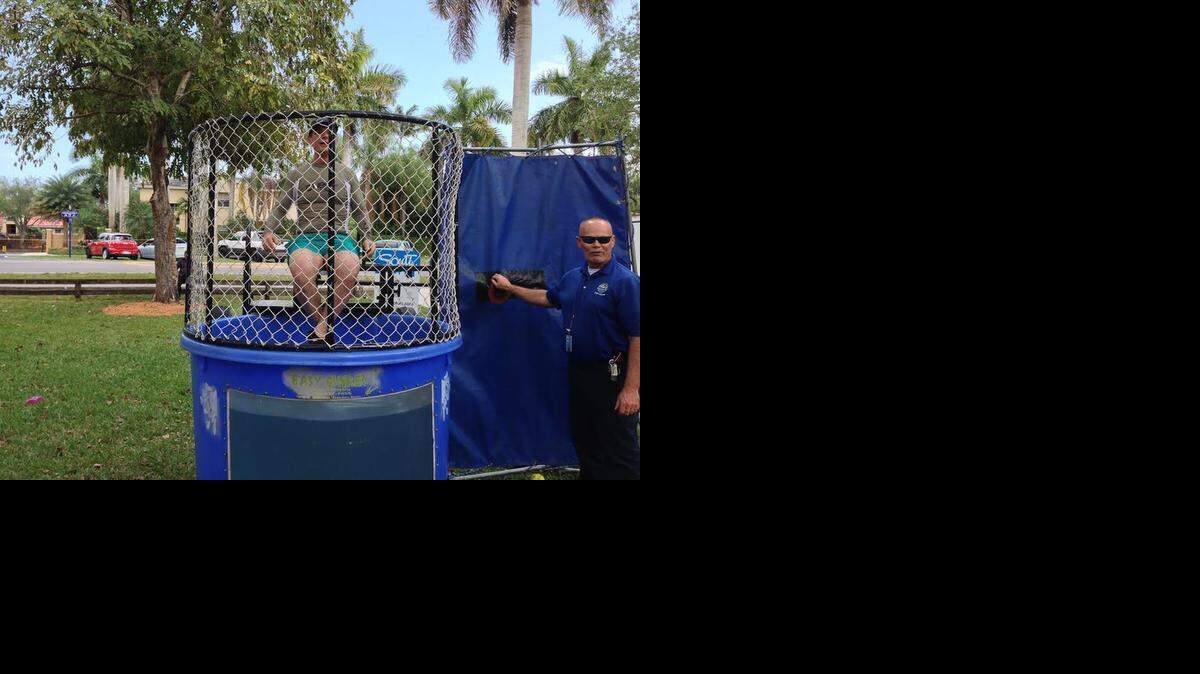 
MAYOR ON HIS THRONE: “If you miss, your taxes go up, Palmetto Bay Mayor Eugene Flinn quips as he sits atop a dunk tank at the village’s 13th annual Celebration Picnic, Saturday, March 7, 2015. Monies raised from the dunk tank were aimed toward Ronald McDonald Charities and Camillus House.
