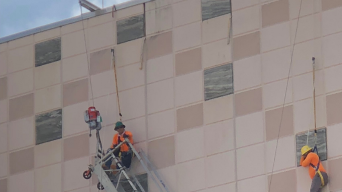 Workers rescued after scaffolding gives way, leaving them dangling off side of building