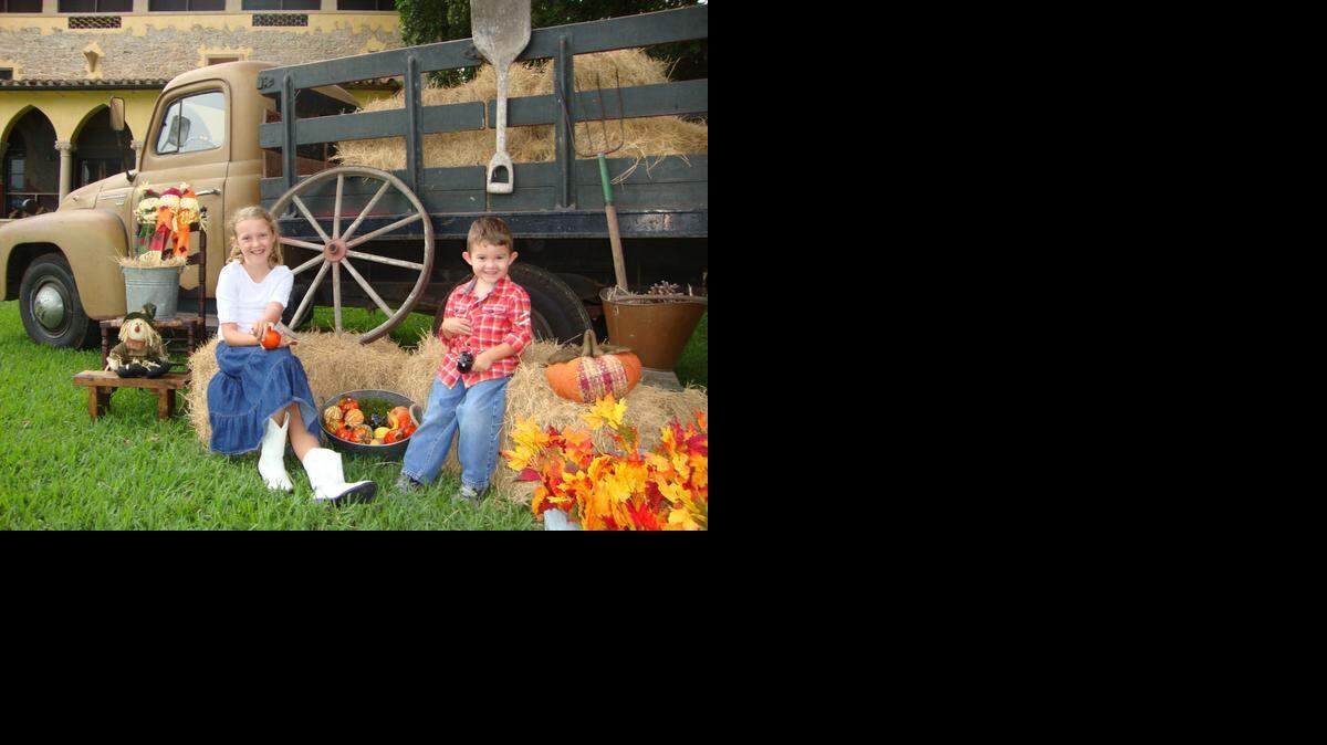 
FALL FUN: Children pose next to the historic International Harvester Truck for the Deering Harvester Day, which will take place Sunday at the Deering Estate at Cutler in Palmetto Bay.



