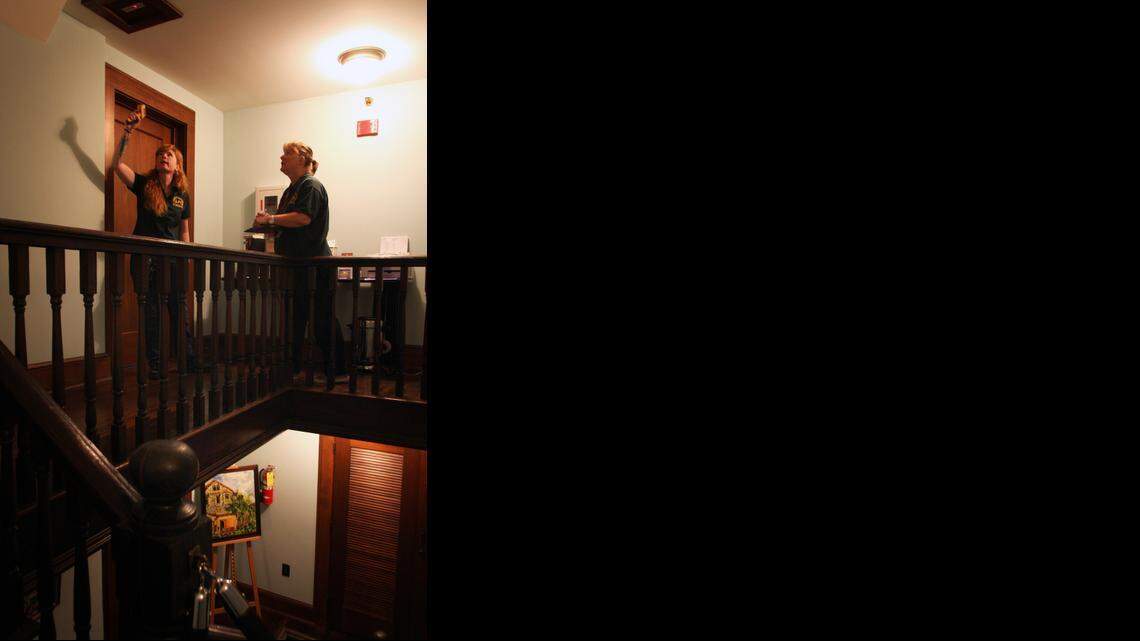 
Naturalists and other employees of the Deering Estate work together with members from the League of Paranormal Investigators to try and communicate with any paranormal activity that may exist on the historic grounds of the Palmetto Bay mansion. Pictured from left, investigator-in-training Bea Henington and investigator Pam Regula take temperature and electro-magnetic frequency readings of the estate's rooms. 
