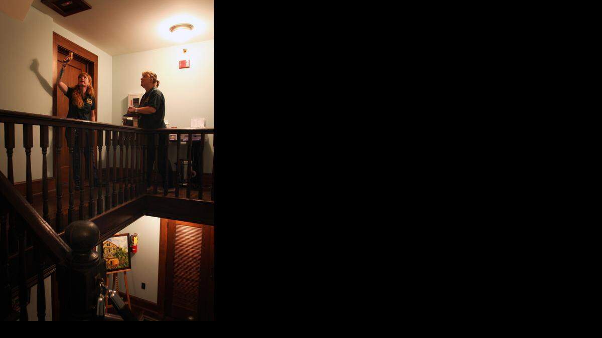 
Naturalists and other employees of the Deering Estate work together with members from the League of Paranormal Investigators to try and communicate with any paranormal activity that may exist on the historic grounds of the Palmetto Bay mansion. Pictured from left, investigator-in-training Bea Henington and investigator Pam Regula take temperature and electro-magnetic frequency readings of the estate's rooms. 
