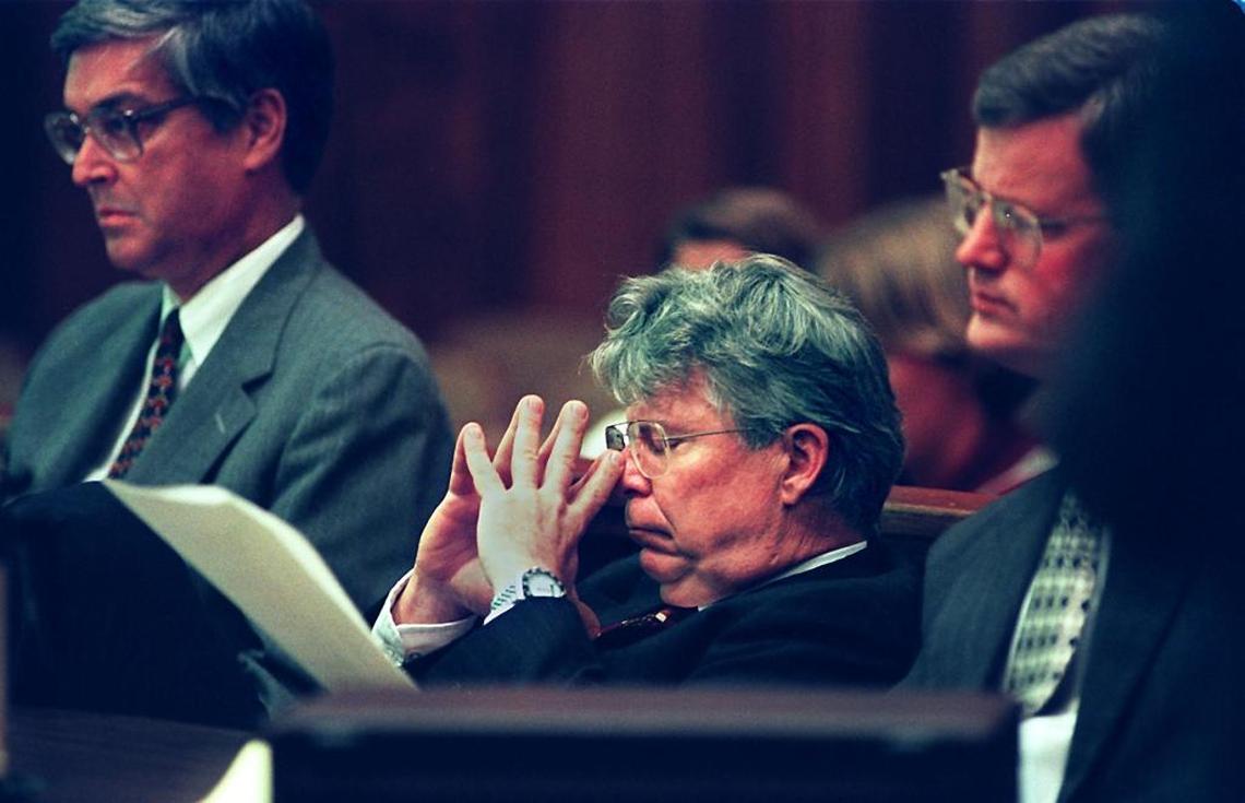 Flanked by his defense attorneys WILLIAM NORRIS (left) and FRITZ MANN, former U.S. Customs agent Henry Blair (center) sloutches down into his seat in a Dade County Courtroom Thursday afternoon as he listens to one of the F.B.I. recordings made of an alleged call to Sue Billig.
