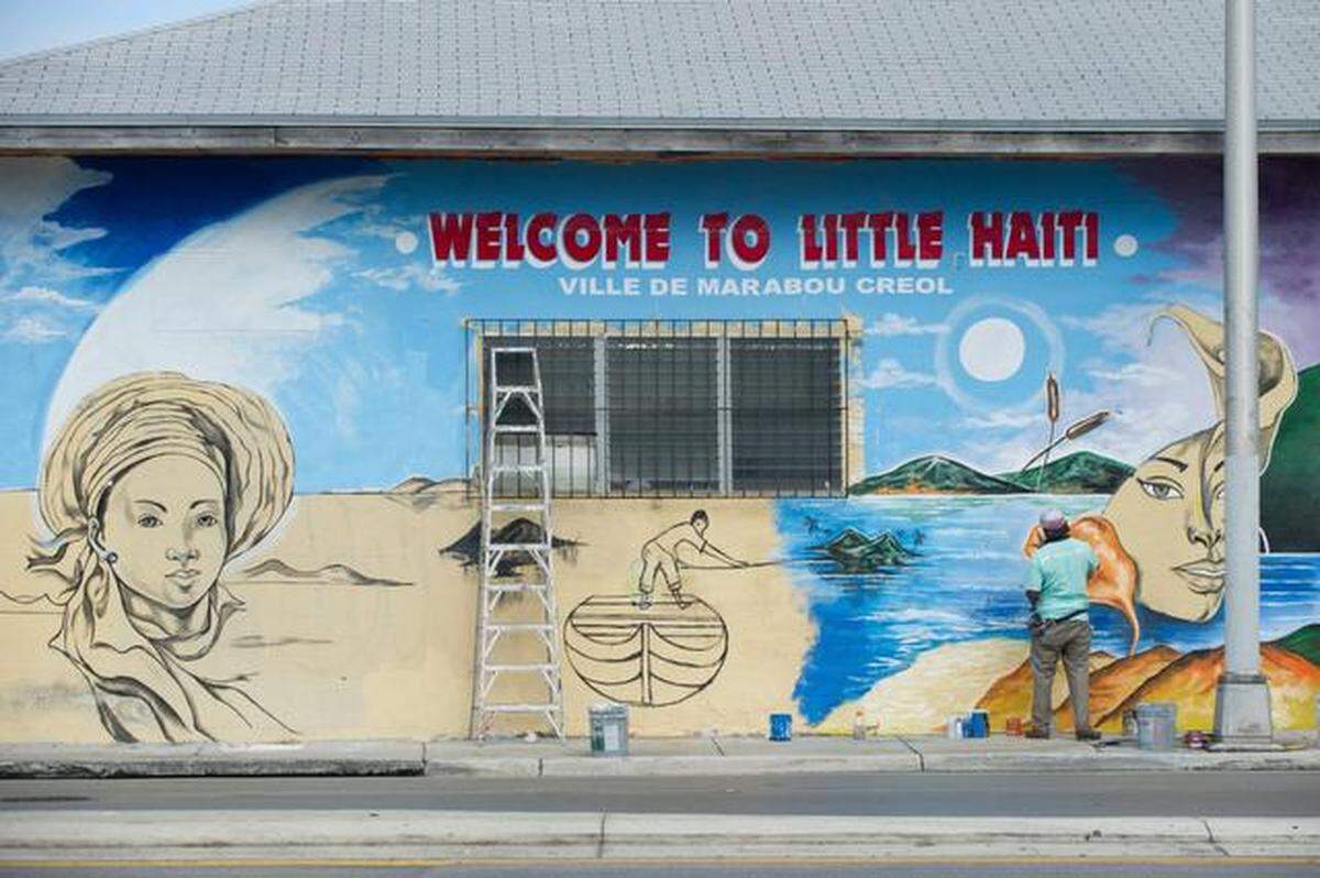 Serge Toussaint works on a mural at the northwest corner of 62nd Street and Northwest Second Avenue in Little Haiti.