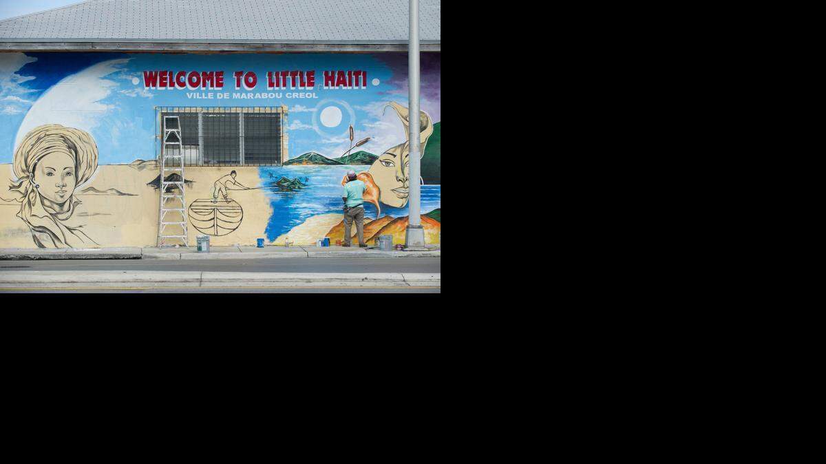 
Serge Toussaint works on a mural at the northwest corner of 62nd Street and Northwest Second Avenue in Little Haiti.
