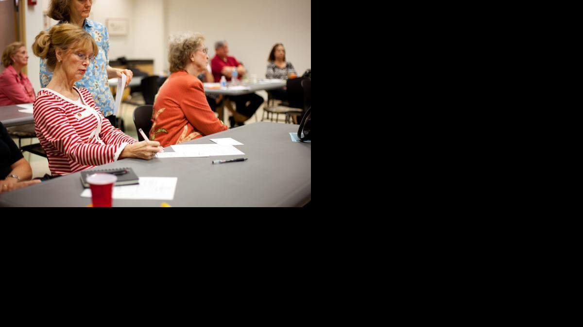 
TRACING A HEALTH HISTORY: Janice Mc Kay, president of the Genealogy Society of Greater Miami, takes notes during a lecture by Derek Dykxhoorn, Ph.D., a leading DNA and chromosome researcher at the University of Miami medical school. He spoke in Pinecrest on Oct. 11 on the importance of tracing your family history for health reasons. 
