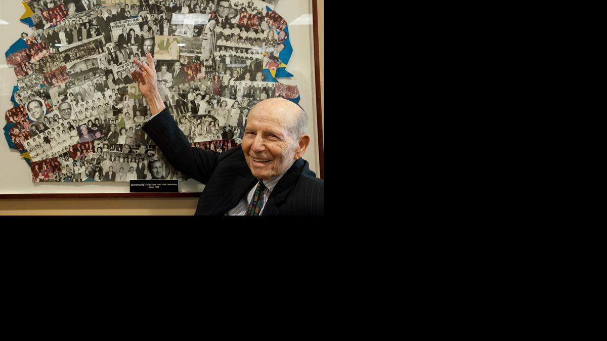 
Rabbi Herbert Baumgard, founding rabbi emeritus at Temple Beth Am, points to a picture of himself included in a collage of photographs, Thursday, April 9, 2015. The temple is celebrating its 60th anniversary.
