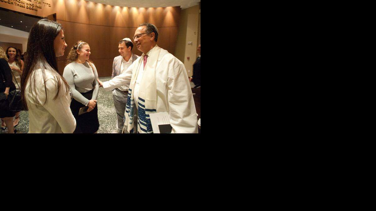 
Rabbi Terry Bookman greets members of his congregation after the Yom Kippur evening service at Temple Beth Am in Pinecrest.  The rabbi plans to retire next year after 20 years at the temple.
