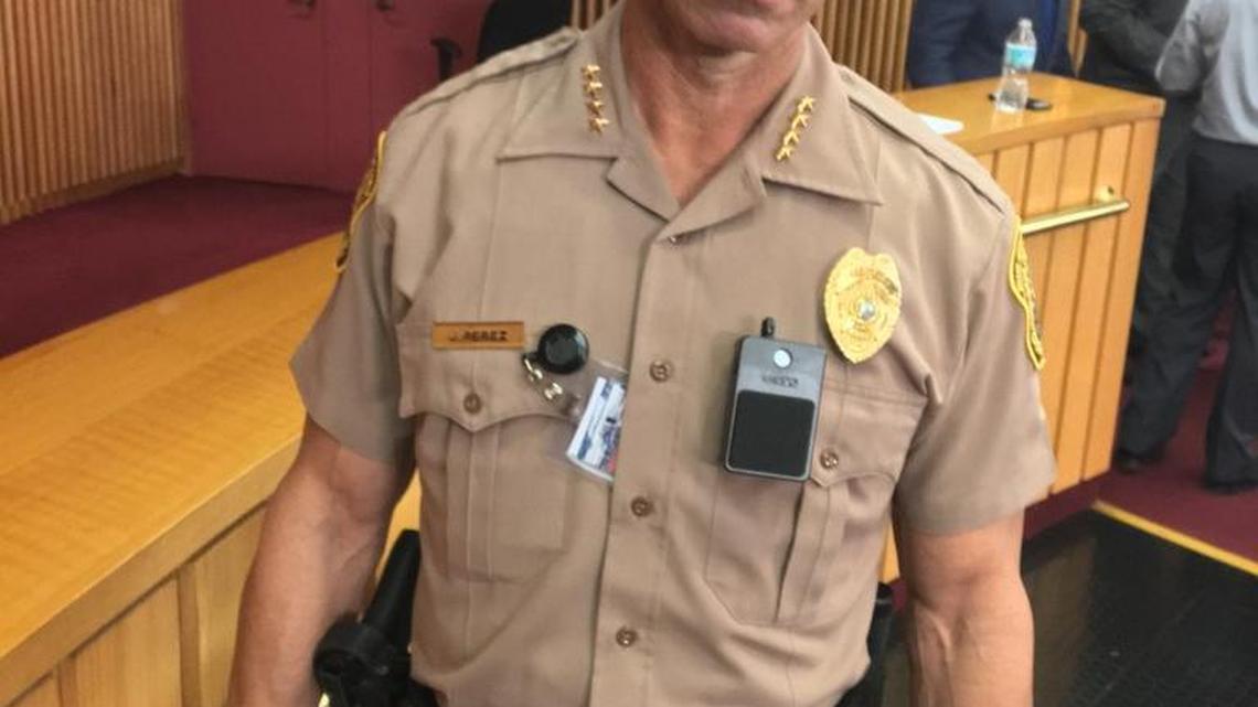 Juan Perez, Miami-Dade’s police director, models a police body-camera (the black device below his badge) before county commissioners approved spending $1 million a year on the cameras on Tuesday.