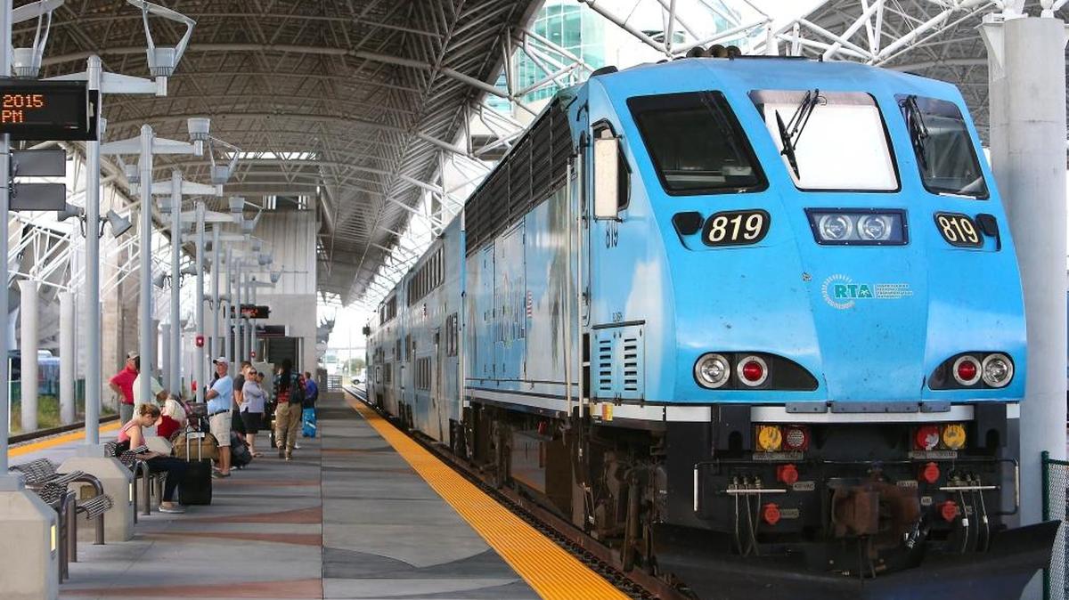 People wait at the Miami International Airport Tri-Rail station.
