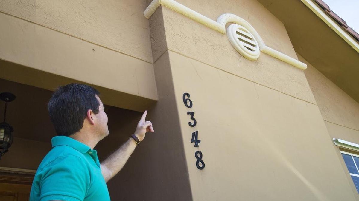 
Ricardo Vazquez, 40, points to exterior structural damages he claims were caused from a blast that occurred three years ago when a marijuana grow operation exploded in front of his home. 

