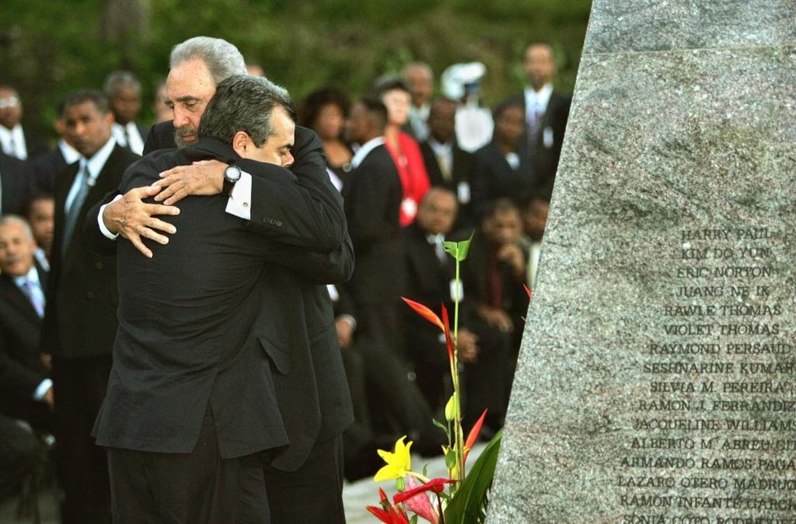 In this 2005 file photo, Cuban leader Fidel Castro hugs Carlos Alberto Cremata, the son of one of the victims of the 1973 bombing of the Cubana Airlines flight from Barbados to Havana, during a wreath-laying ceremony at a memorial to the 73 people killed.