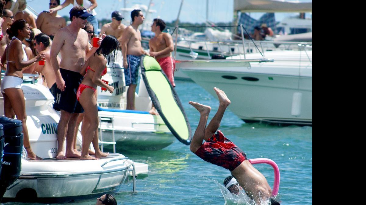 
This 2002 file photo from the Columbus Day Regatta shows the tradition of floating parties that has Miami-Dade County cracking down on boat raft-ups. 
