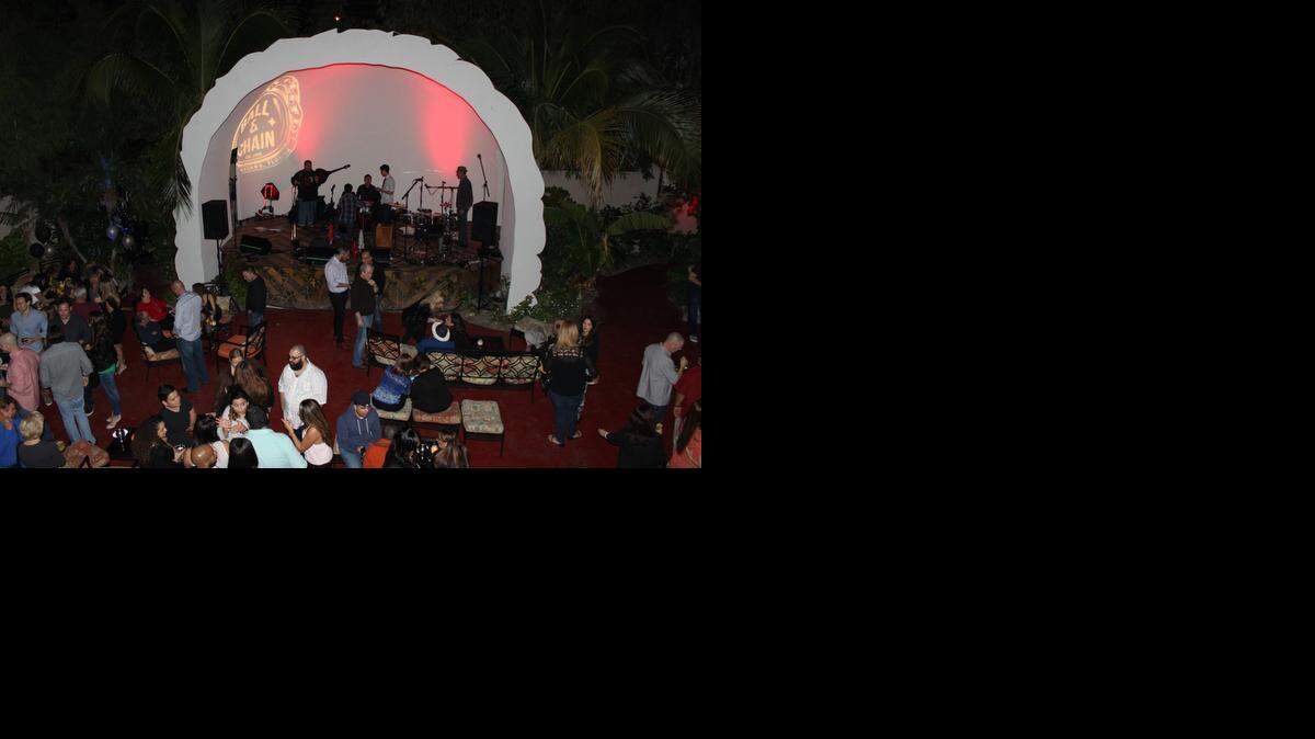 
On Saturdays, “La Pachanga” musicians arrive and gather at the patio's lit stage to prepare for the night's Latin musical performance.
