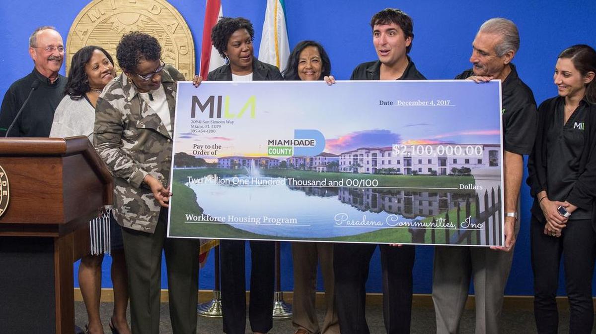 A publicity photo from Dec. 4 shows Pasadena Homes executives turning over a $2.1 million check to Miami-Dade Commissioner Barbara Jordan, third from left, for the county’s Affordable Housing Trust Fund. Although the fund has been in existence for 10 years, Pasadena’s contribution was its largest in history and accounts for more than a third of the fund’s $5.7 million balance.