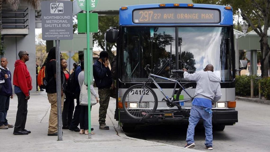 Jeremiah and Tracey Pringle and Alvin Crosby board a bus at the MLK Metrorail stop.